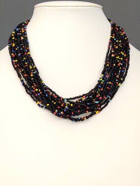 Multi strand black seed bead necklace with bright bead accents